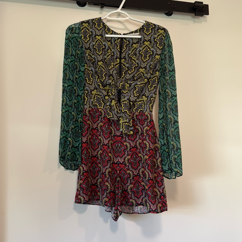 Used short romper 
Zipper in back 
Bell sleeve
Tie in front 
Cut out in front